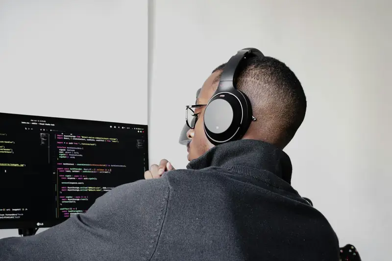 A developer with headphones writing code