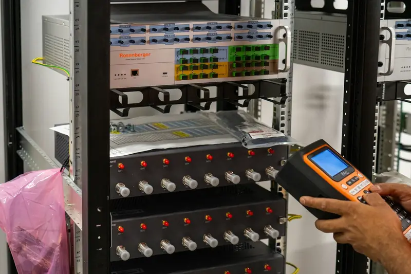 A technician configuring equipment in a server rack