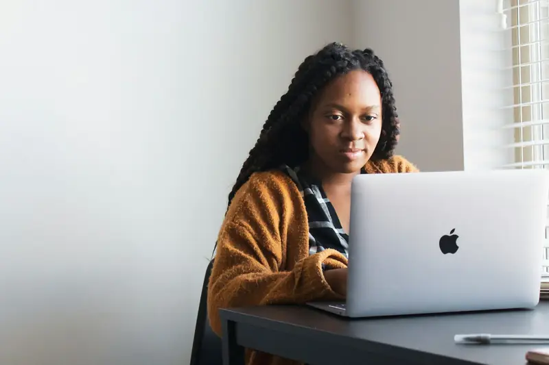 A woman working on a web application on her laptop